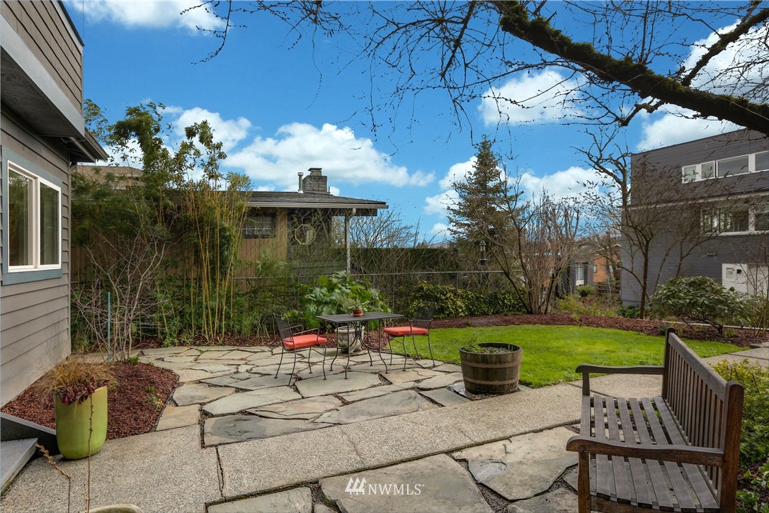 2418 East Roy Street Seattle, WA 98112 - Photo 4 of 32 a view of a chair and tables in the patio