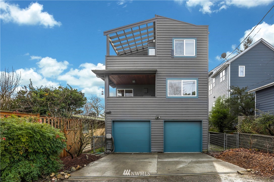 2418 East Roy Street Seattle, WA 98112 - Photo 31 of 32 a front view of a house with a garden