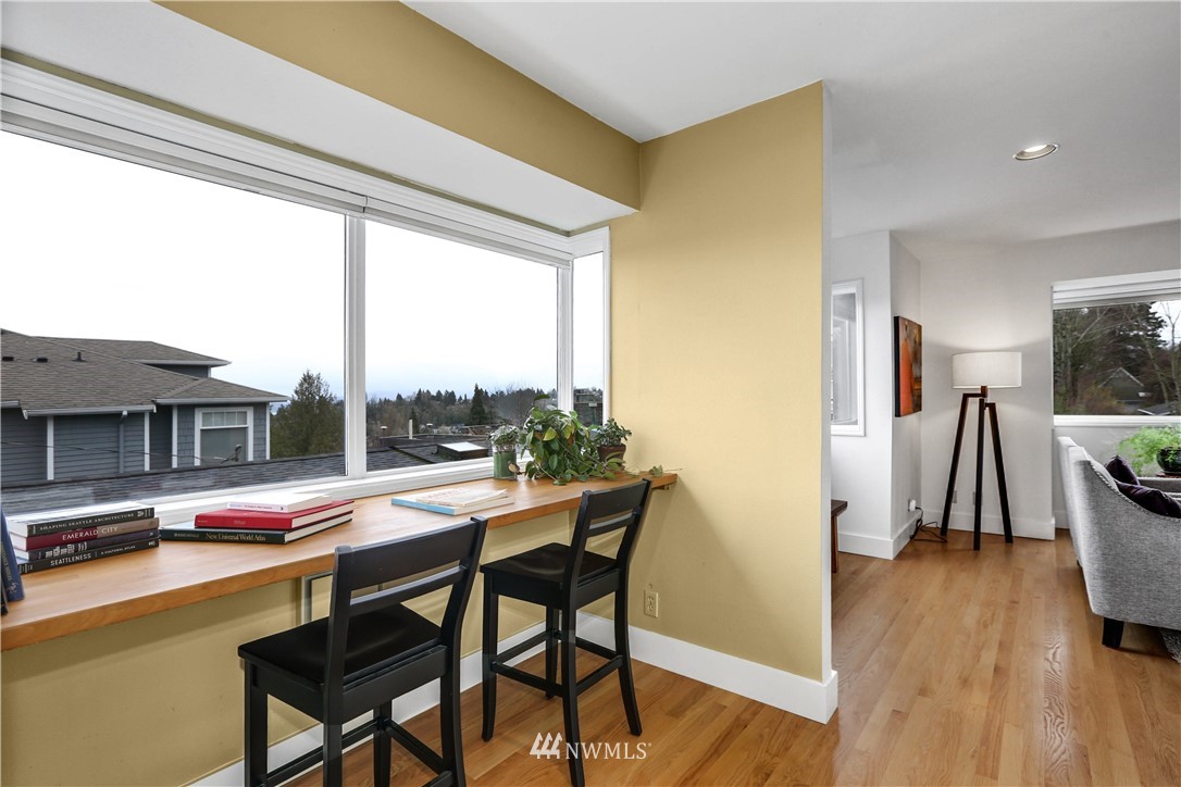 2418 East Roy Street Seattle, WA 98112 - Photo 9 of 32 a dining room with furniture and a wooden floor