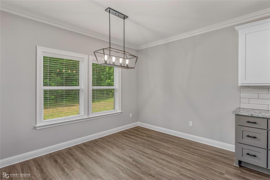 1013 VOSS Road Stonewall, LA 71078 - Photo 15 of 32 a view of wooden floor and windows in a room