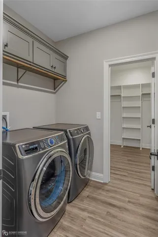 a utility room with closet dryer and washer