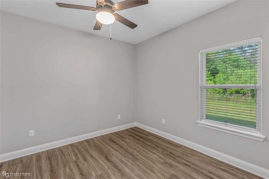 1013 VOSS Road Stonewall, LA 71078 - Photo 30 of 32 a view of an empty room with wooden floor and a window