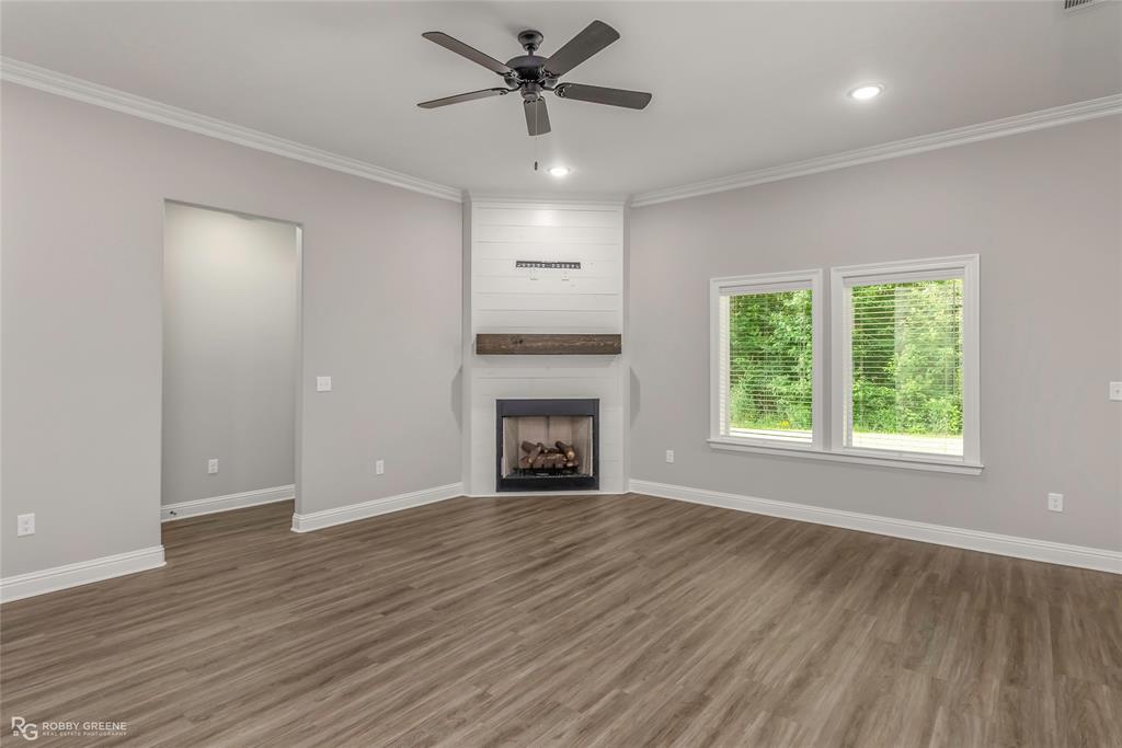 1013 VOSS Road Stonewall, LA 71078 - Photo 9 of 32 a view of an empty room with a window and fireplace