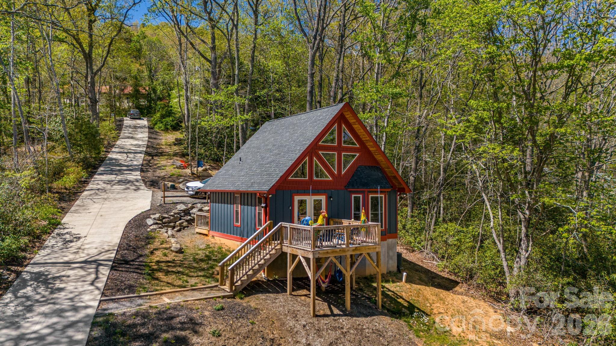 67-69 Flat Top Mountain Road Fairview, NC 28730 - Photo 1 of 43 an aerial view of a house with swimming pool