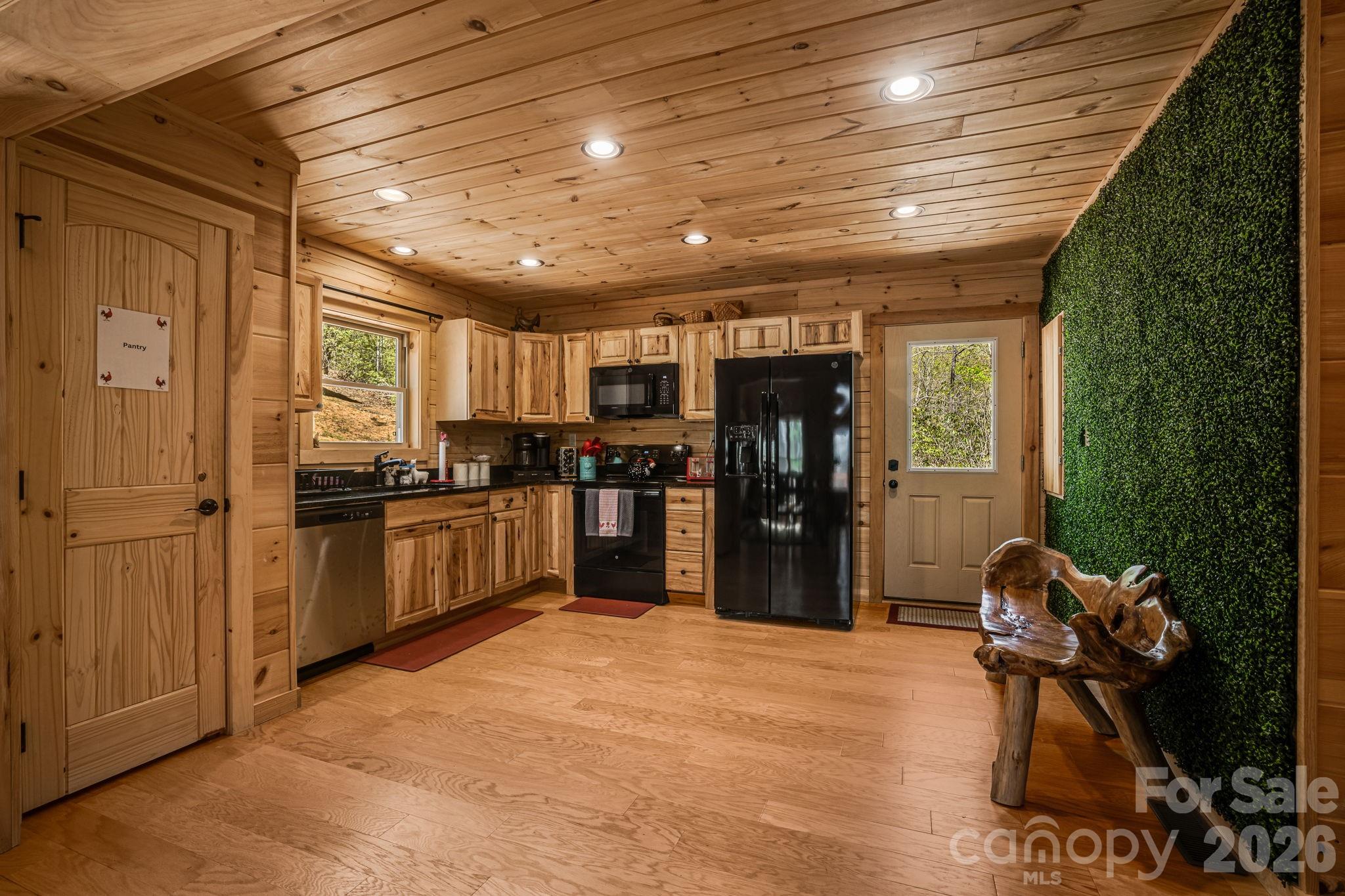 67-69 Flat Top Mountain Road Fairview, NC 28730 - Photo 21 of 43 a kitchen with refrigerator and chairs