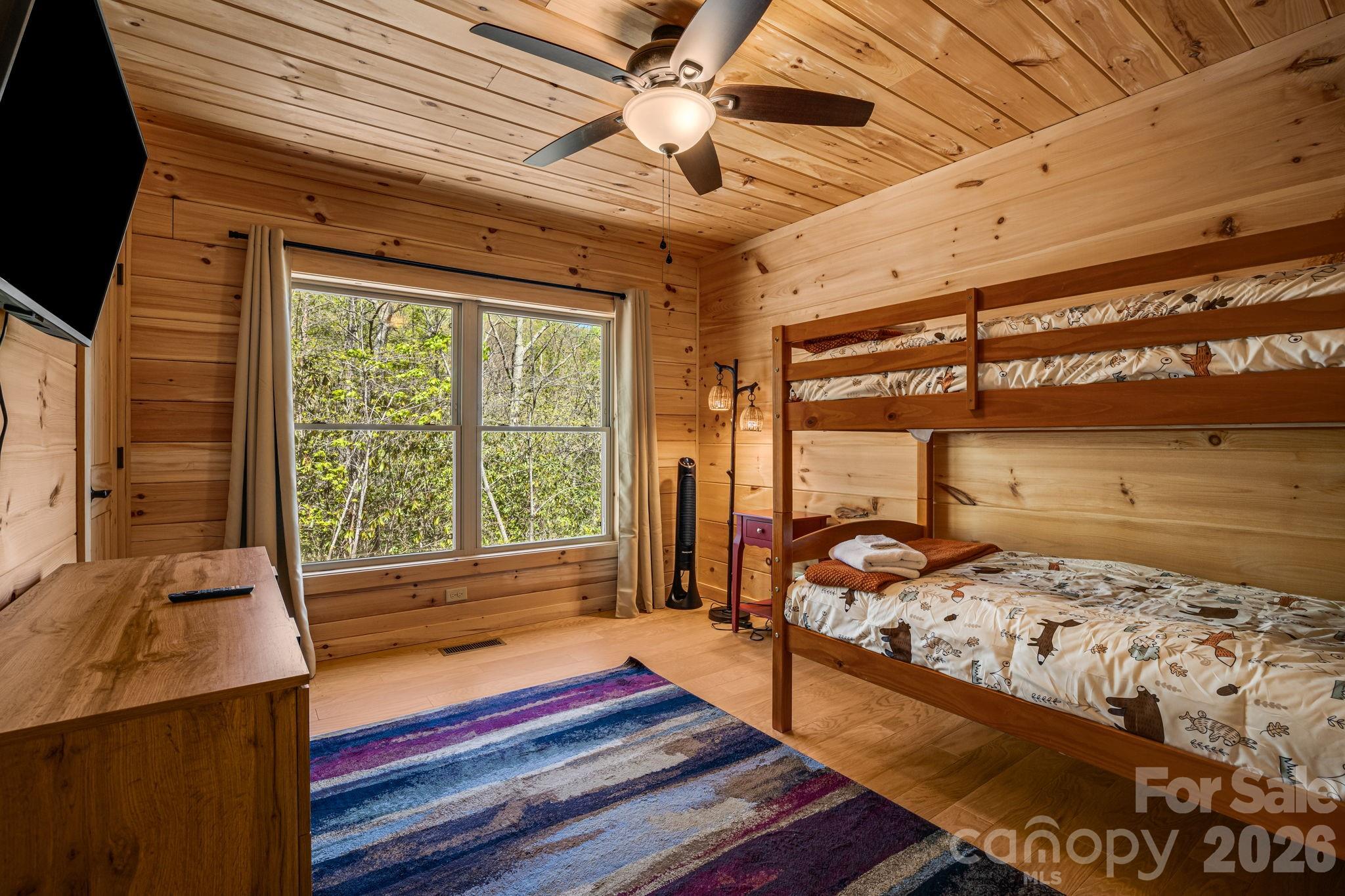 67-69 Flat Top Mountain Road Fairview, NC 28730 - Photo 23 of 43 a bedroom with furniture and a window