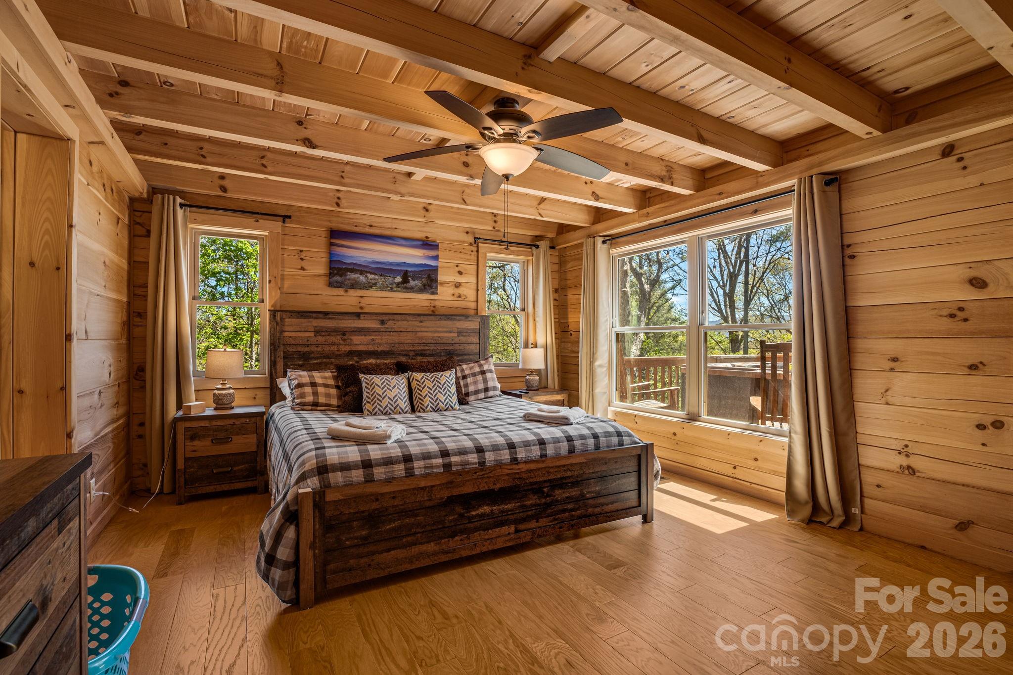 67-69 Flat Top Mountain Road Fairview, NC 28730 - Photo 25 of 43 a bedroom with a bed with wooden floor