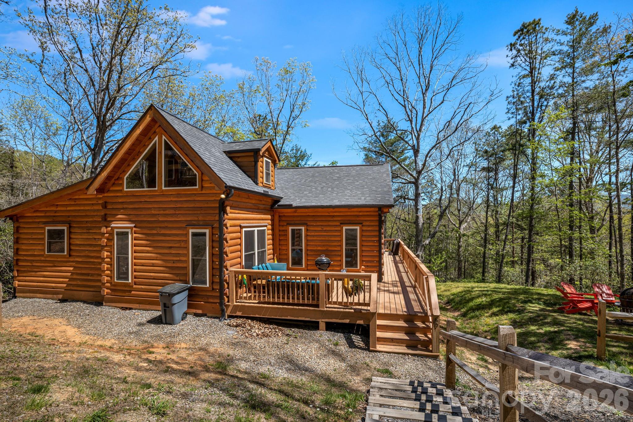 67-69 Flat Top Mountain Road Fairview, NC 28730 - Photo 31 of 43 a front view of house with yard and trees in the background
