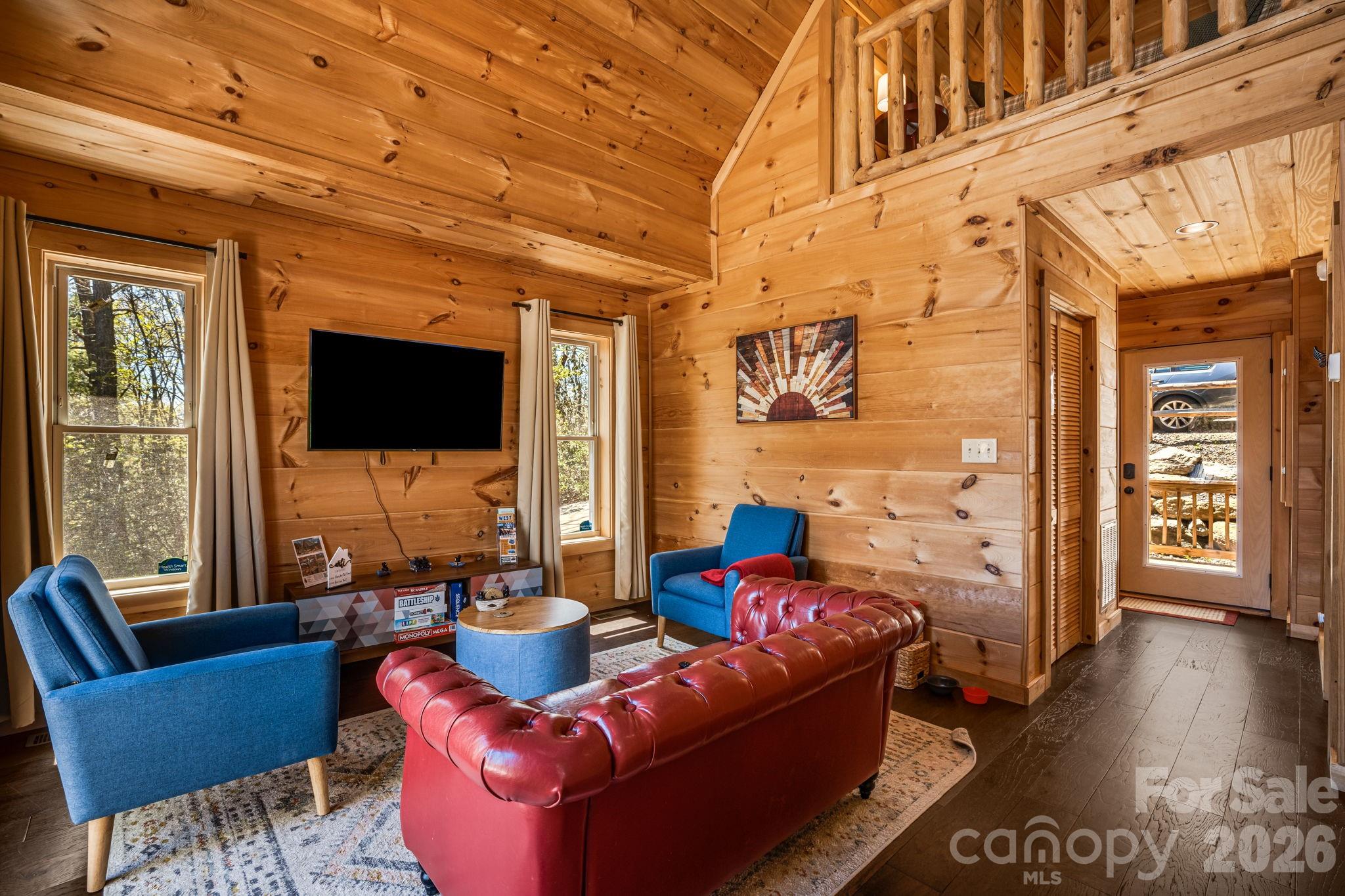 67-69 Flat Top Mountain Road Fairview, NC 28730 - Photo 32 of 43 a living room with furniture a flat screen tv and a fireplace