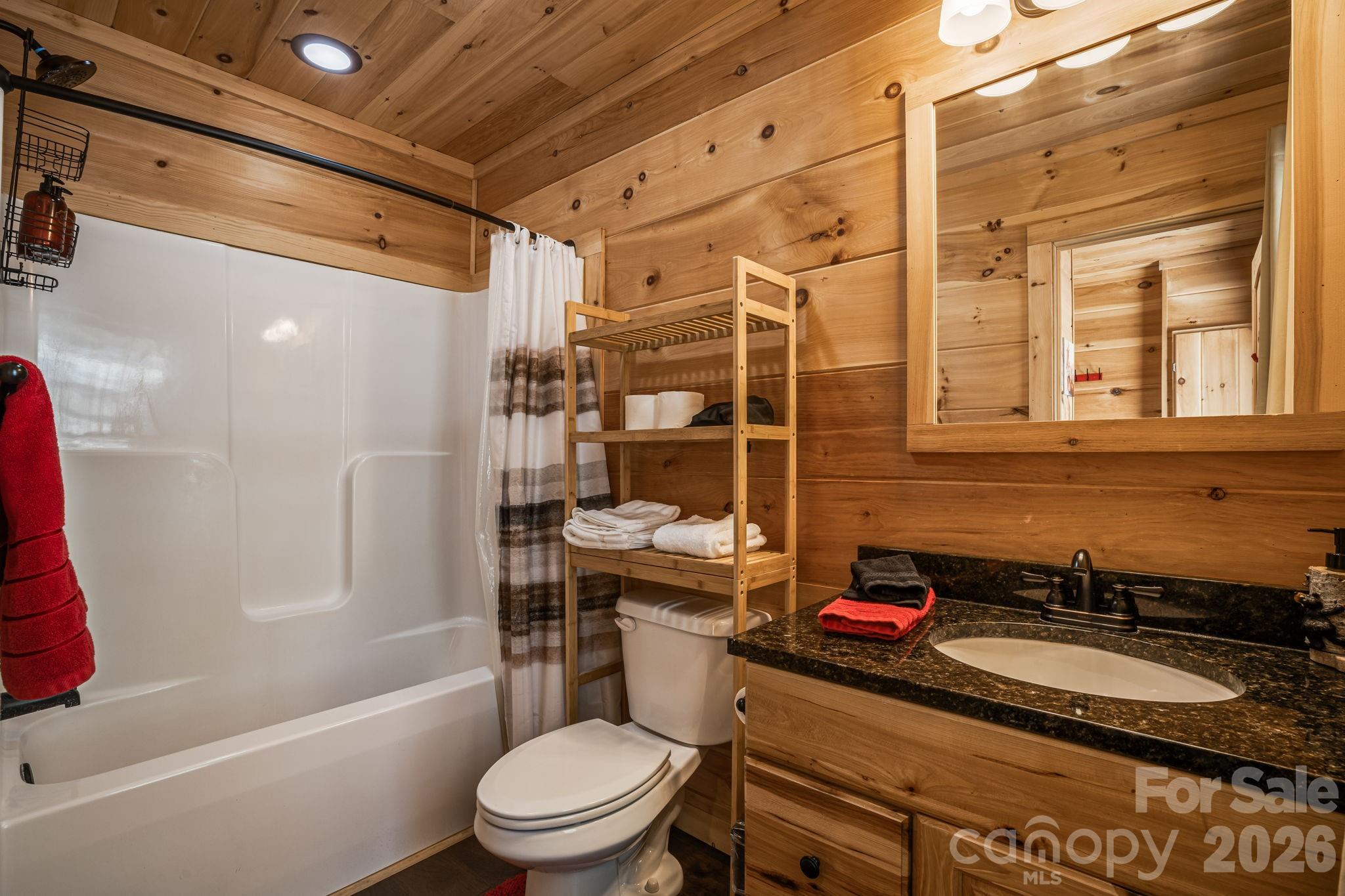 67-69 Flat Top Mountain Road Fairview, NC 28730 - Photo 35 of 43 a bathroom with a sink toilet vanity and shower