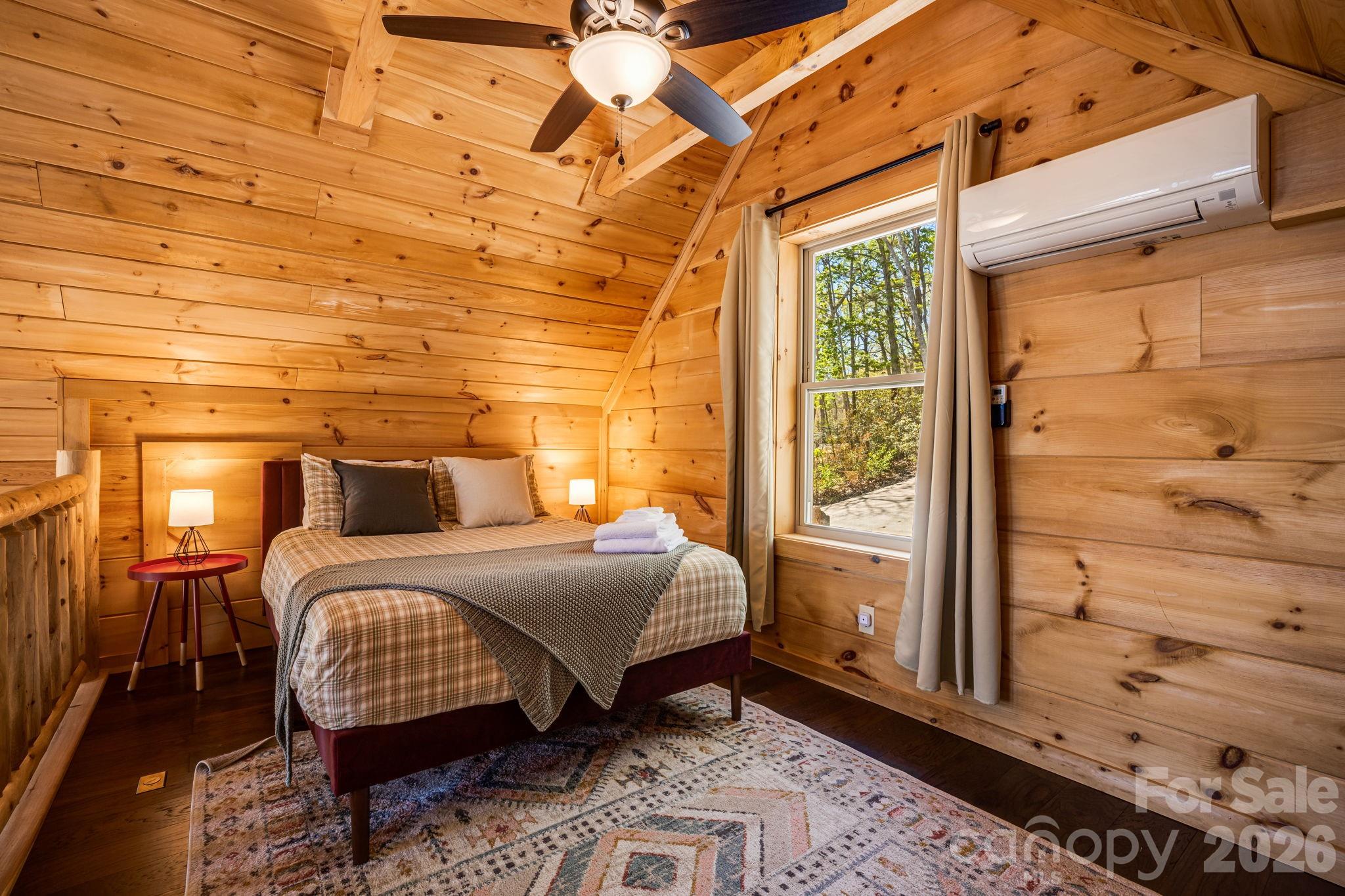 67-69 Flat Top Mountain Road Fairview, NC 28730 - Photo 40 of 43 a bedroom with a bed and wooden floor