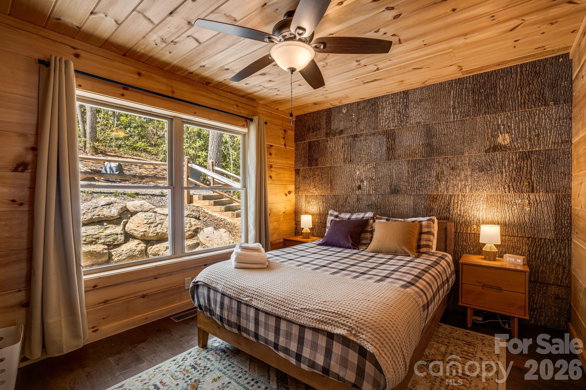 67-69 Flat Top Mountain Road Fairview, NC 28730 - Photo 41 of 43 a bedroom with a bed next to a window