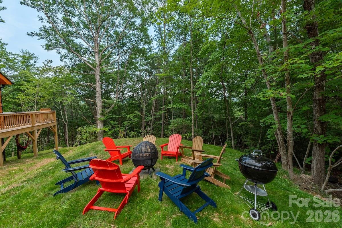 67-69 Flat Top Mountain Road Fairview, NC 28730 - Photo 6 of 43 a backyard of a house with table and chairs