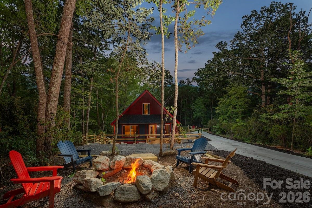 67-69 Flat Top Mountain Road Fairview, NC 28730 - Photo 7 of 43 a view of a chairs and tables in the backyard of a house