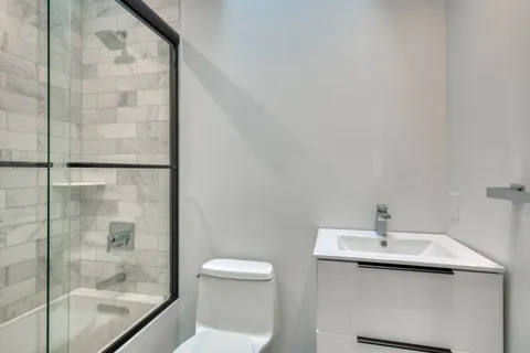a bathroom with a sink toilet and shower