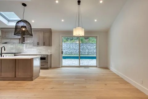 a view of a kitchen with a sink and chandelier