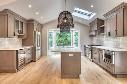 a kitchen with stainless steel appliances granite countertop a stove and a sink