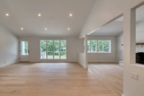 an empty room with windows and yard