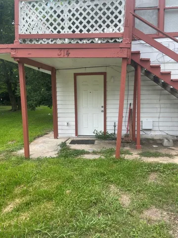 a view of a house with a yard and a chair