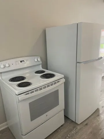 a stove top oven sitting inside of a kitchen