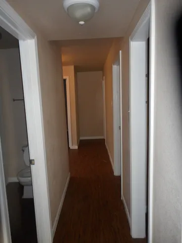 a view of a hallway with a wooden floor