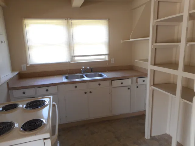 a utility room with cabinets washer and dryer