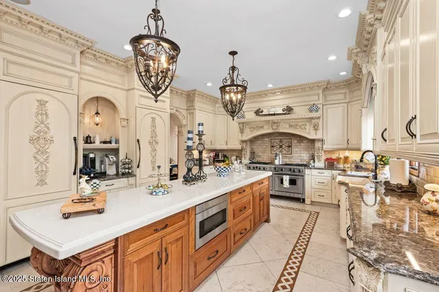 a kitchen with stainless steel appliances kitchen island granite countertop a sink and cabinets