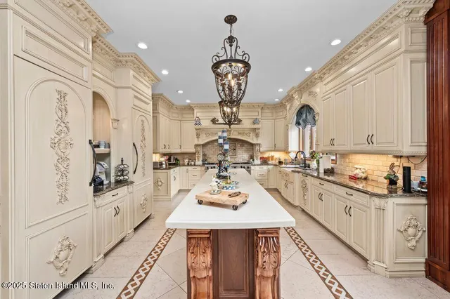 a kitchen with white cabinets and appliances