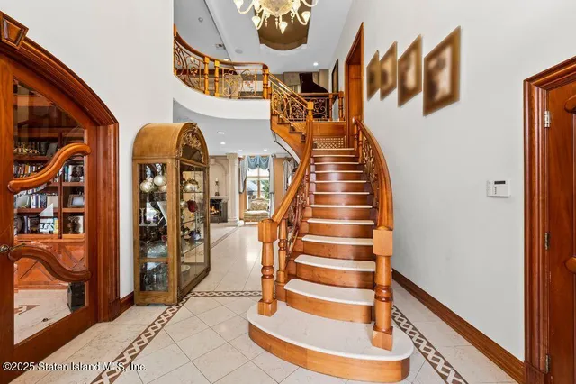 a dining room with furniture a fireplace a rug and kitchen view