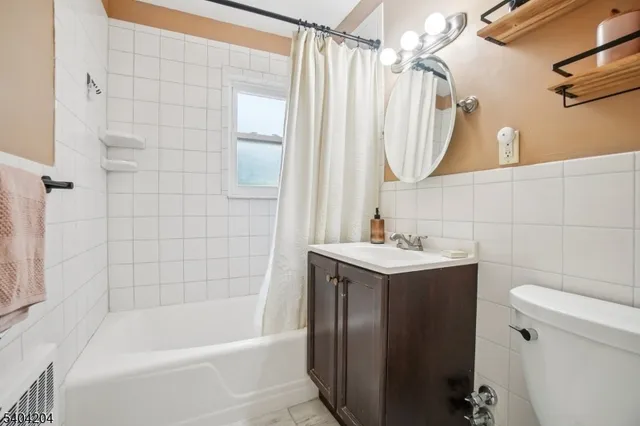 a bathroom with a sink mirror toilet and bathtub