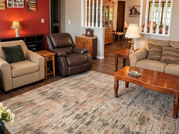 a living room with furniture and a wooden floor