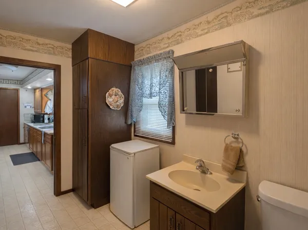 a bathroom with a toilet sink and mirror