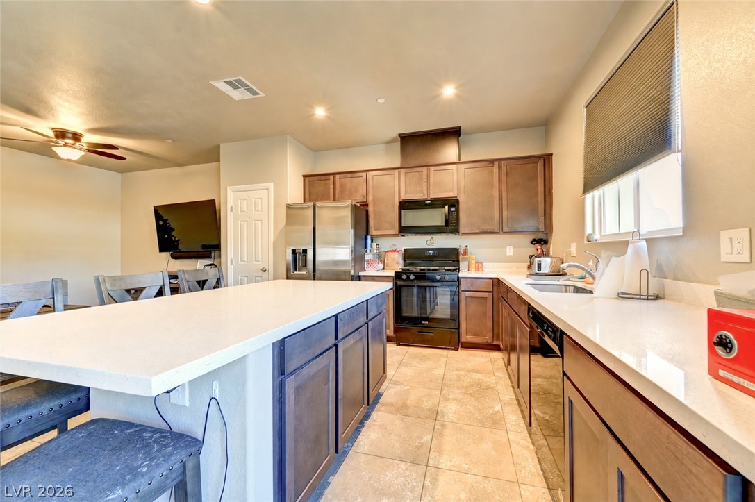 1284 Arcadia Rim Place Henderson, NV 89002 - Photo 7 of 24 An inviting open-concept kitchen features a spacious island and well-appointed appliances.