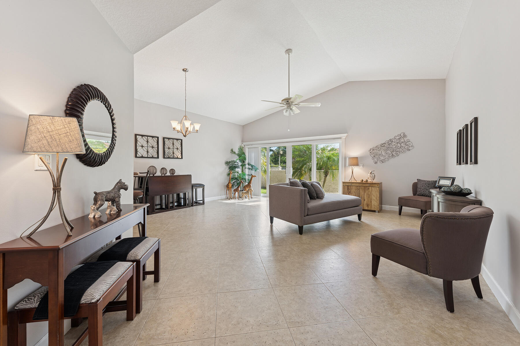 6276 Sweet Maple Lane Boca Raton, FL 33433 - Photo 2 of 14 a living room with furniture a fireplace and a chandelier