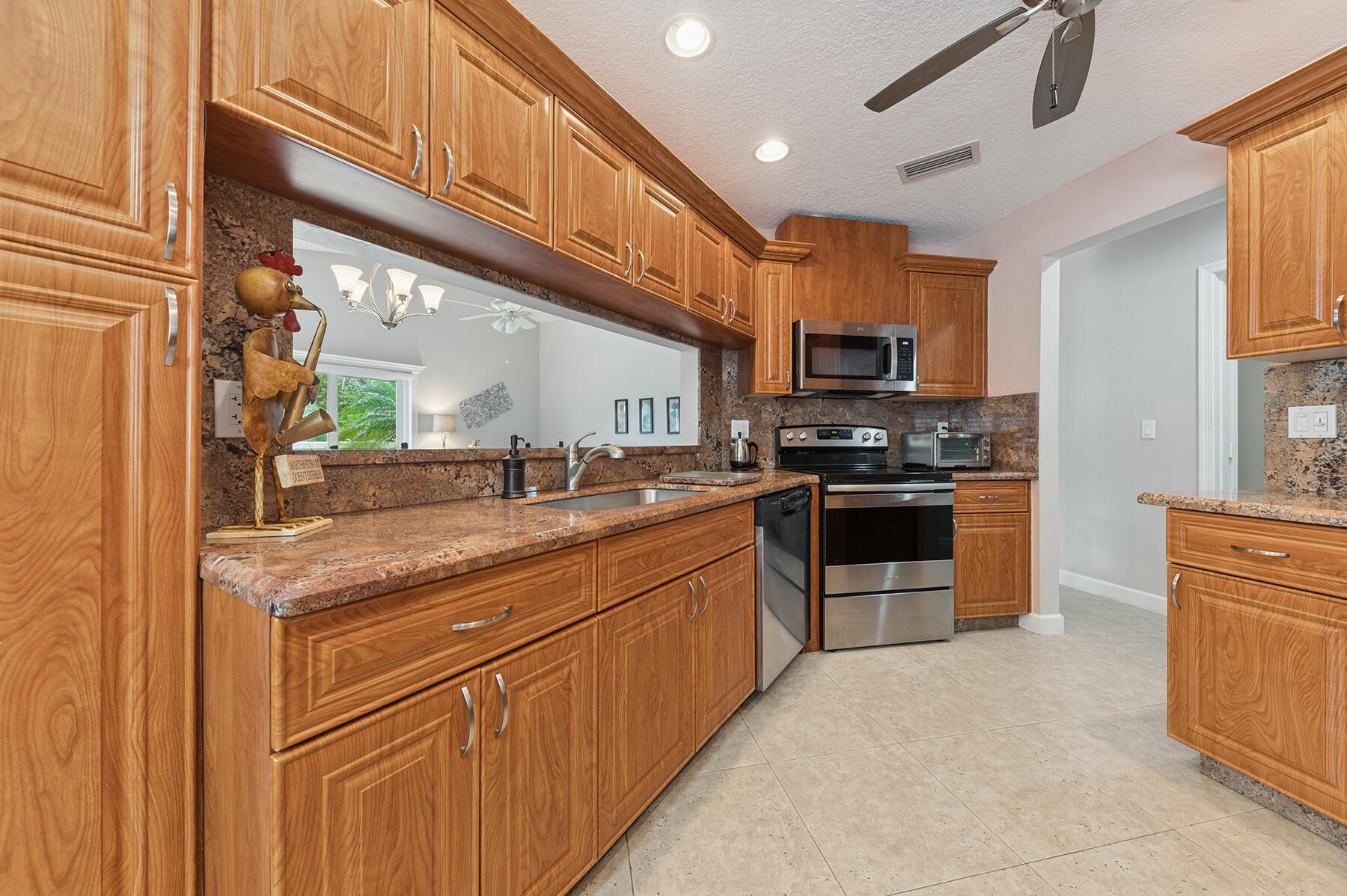 6276 Sweet Maple Lane Boca Raton, FL 33433 - Photo 7 of 14 a kitchen with stainless steel appliances granite countertop a stove and a sink