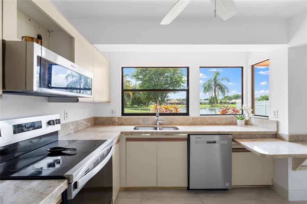 9477 Burlington Place Boca Raton, FL 33434 - Photo 12 of 40 a kitchen with a sink stove and window