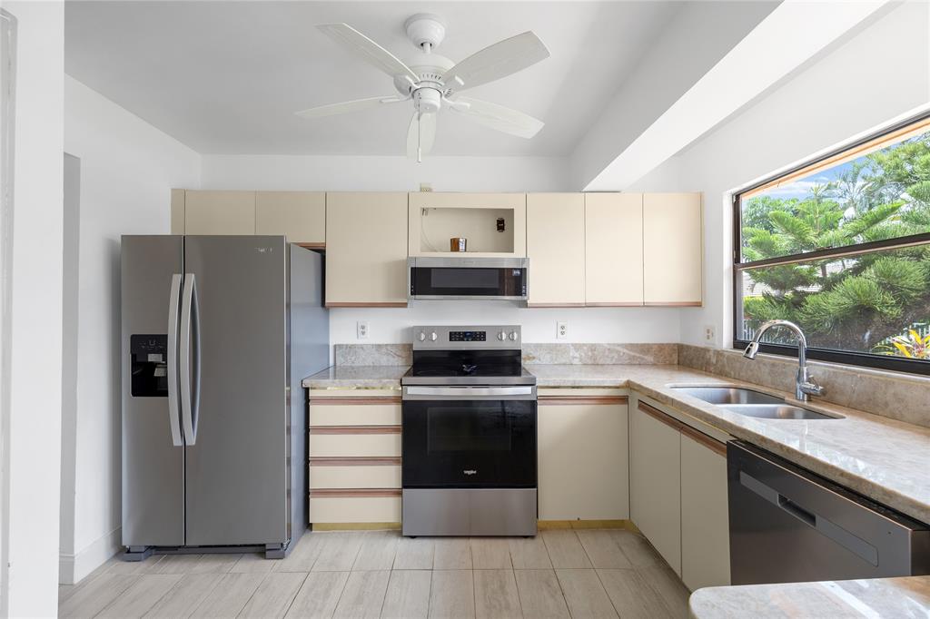9477 Burlington Place Boca Raton, FL 33434 - Photo 13 of 40 a kitchen with a sink stove and refrigerator