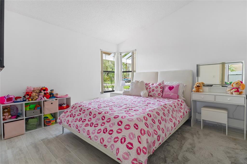 9477 Burlington Place Boca Raton, FL 33434 - Photo 17 of 40 a bedroom with a bed and a window