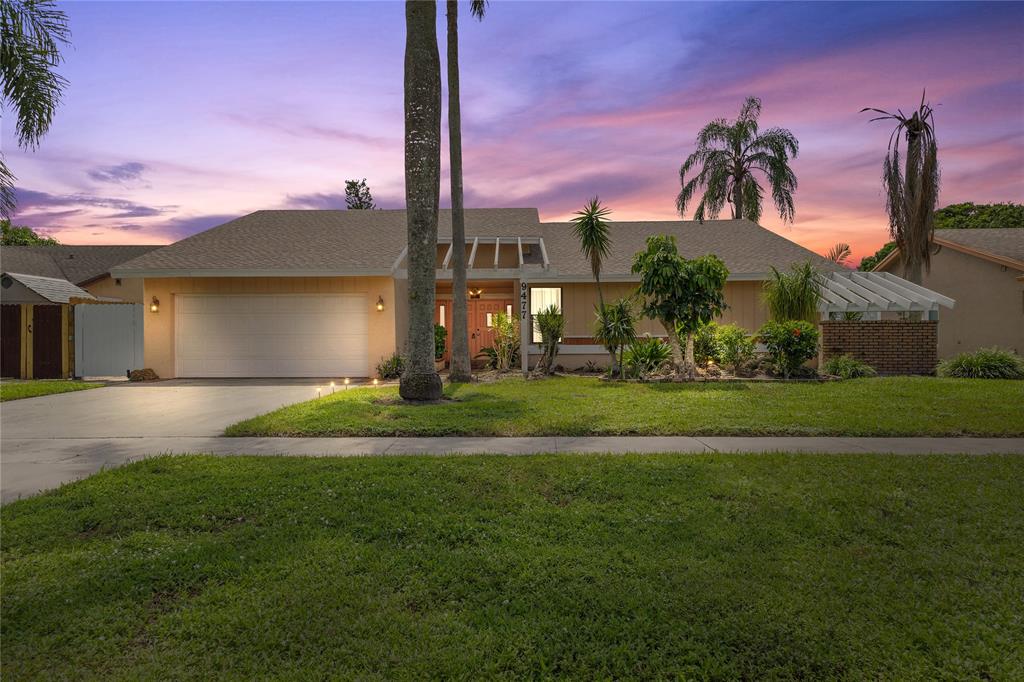 9477 Burlington Place Boca Raton, FL 33434 - Photo 2 of 40 a front view of a house with garden and entertaining space