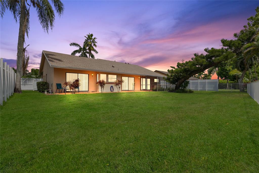 9477 Burlington Place Boca Raton, FL 33434 - Photo 40 of 40 a view of an house with backyard space and garden