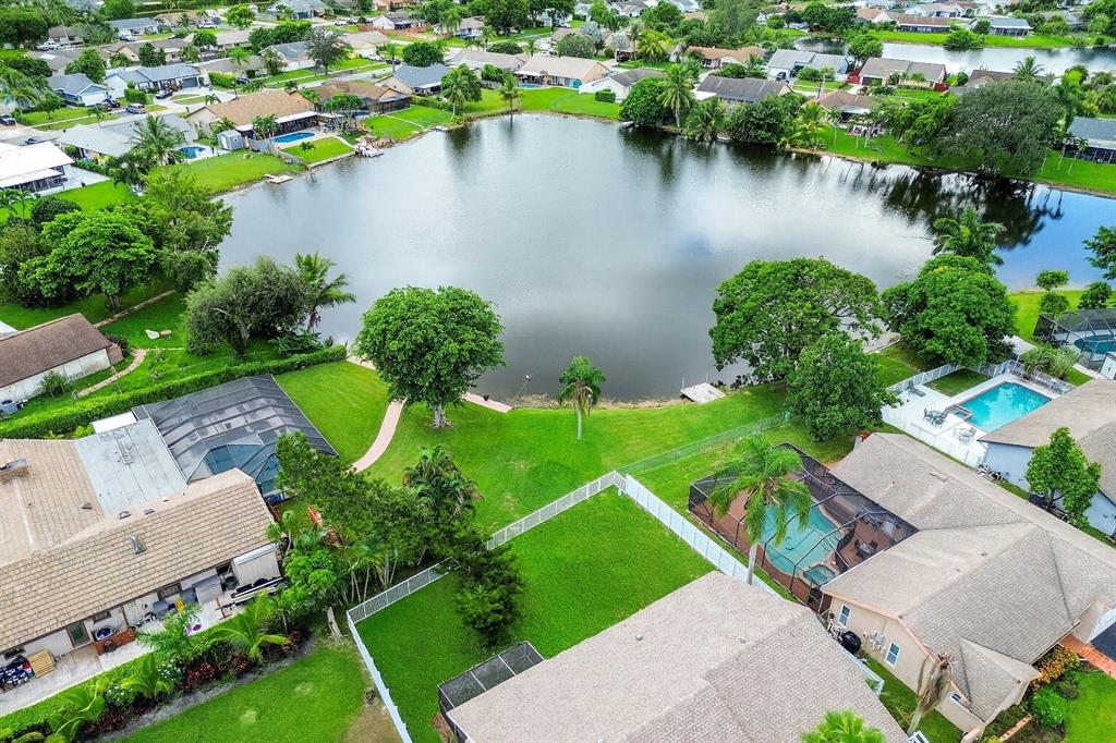 9477 Burlington Place Boca Raton, FL 33434 - Photo 5 of 40 an aerial view of a house with a yard and lake view