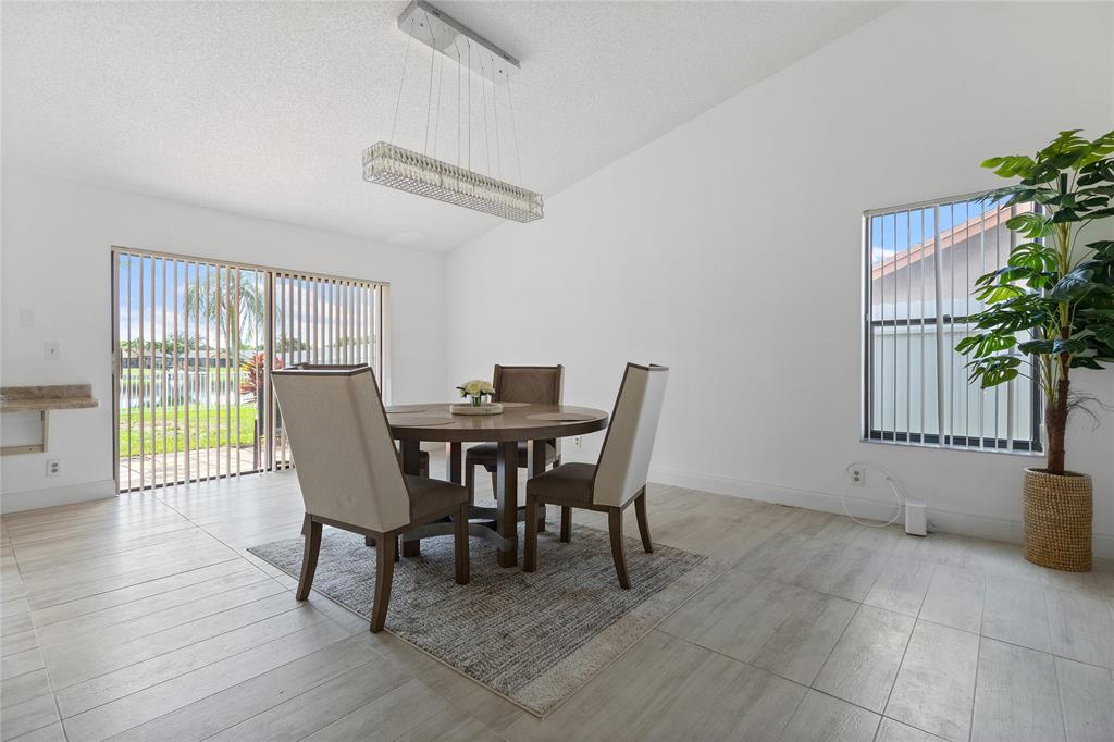 9477 Burlington Place Boca Raton, FL 33434 - Photo 8 of 40 a view of a dining room with furniture and a potted plant