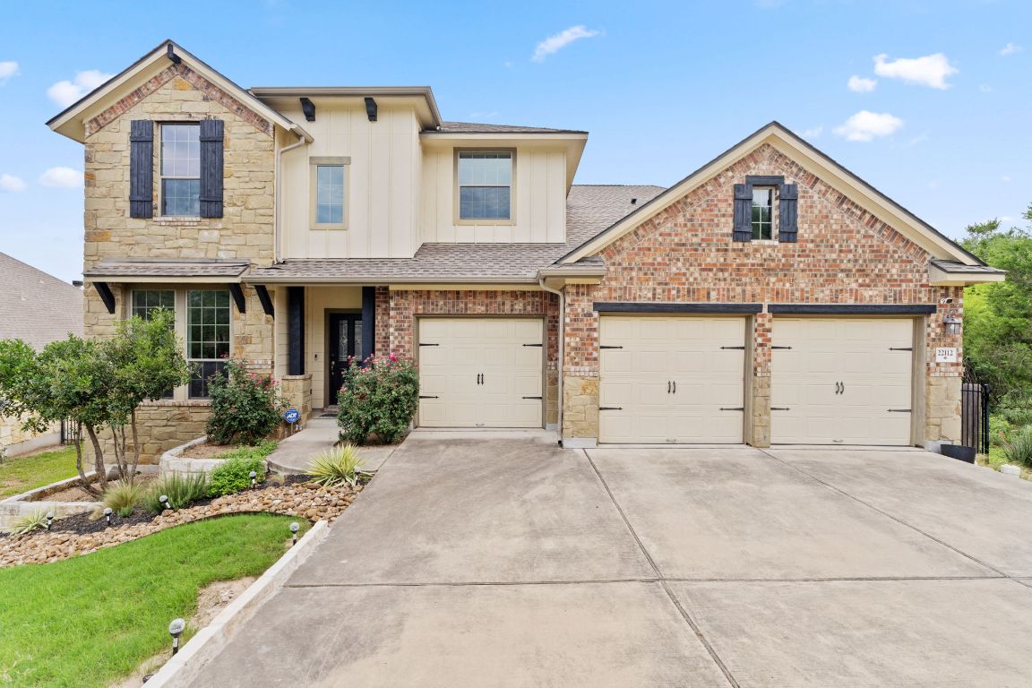 Undisclosed Address Spicewood, TX 78669 - Photo 1 of 1 View of front of house featuring driveway, a shingled roof, board and batten siding, and stone siding