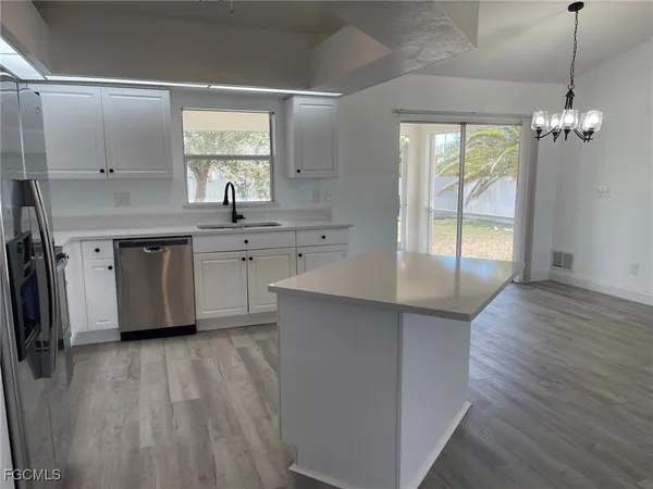 a spacious bathroom with a granite countertop sink window and a mirror