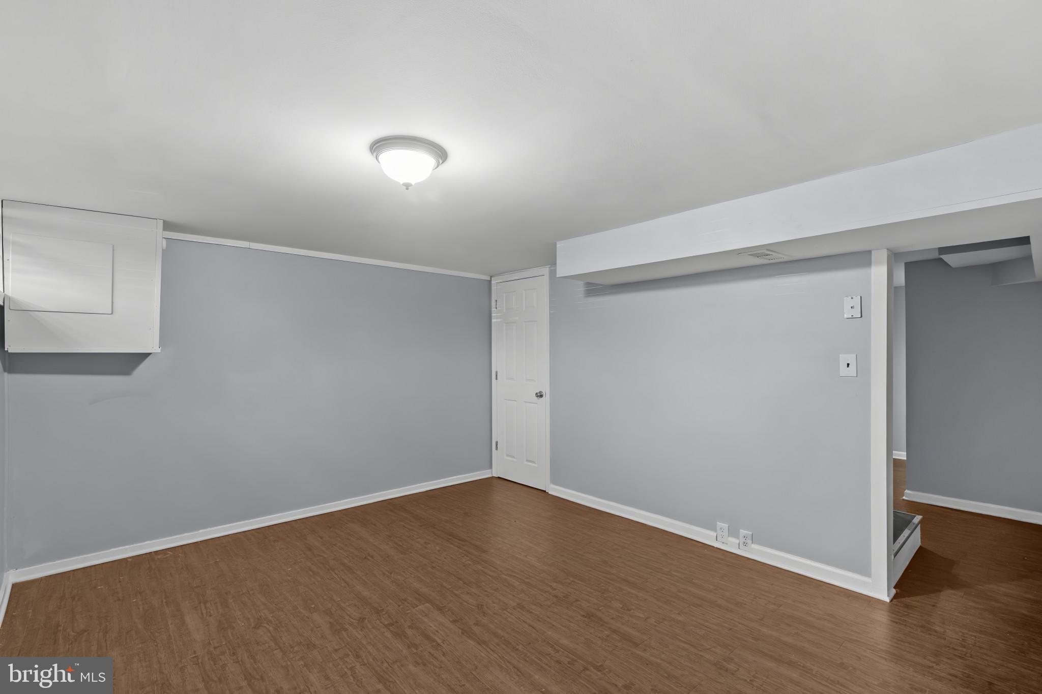 749 South Woodington Road Baltimore, MD 21229 - Photo 15 of 18 a view of an empty room with wooden floor