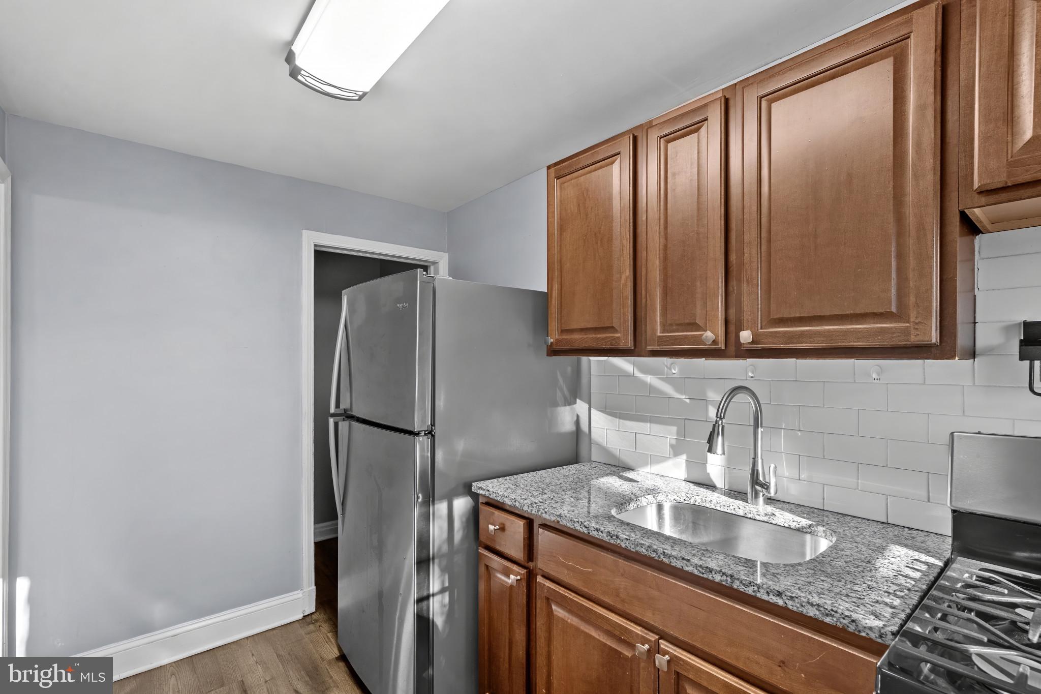 749 South Woodington Road Baltimore, MD 21229 - Photo 8 of 18 a kitchen with stainless steel appliances granite countertop a refrigerator a sink and dishwasher
