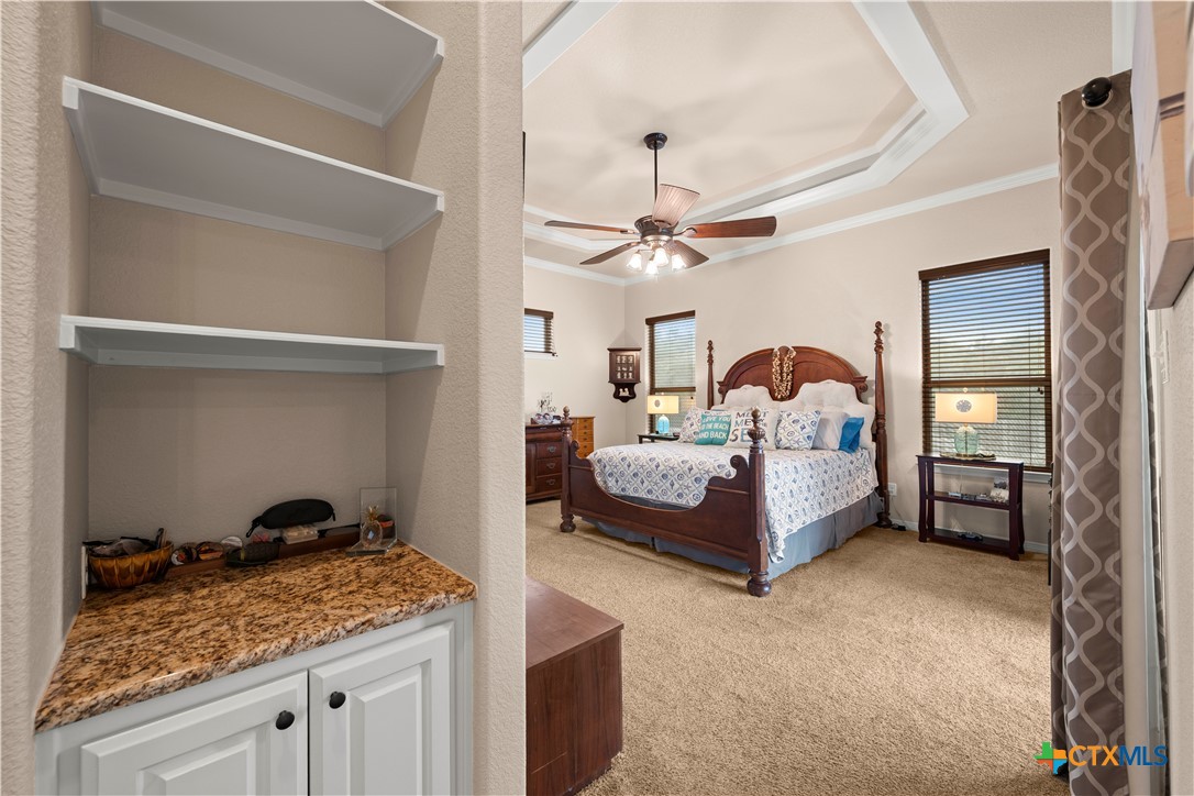 2649 Bowles Ranch Road Belton, TX 76513 - Photo 13 of 36 a bedroom with a bed and a chandelier