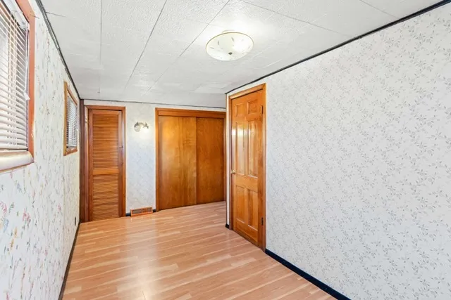 a view of a room with wooden floor and bathroom