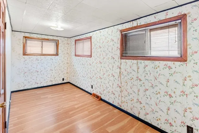 a view of a room with a wooden floor and a window