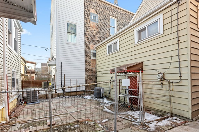 3047 South Broad Street Chicago, IL 60608 - Photo 16 of 25 a view of a house with wooden fence